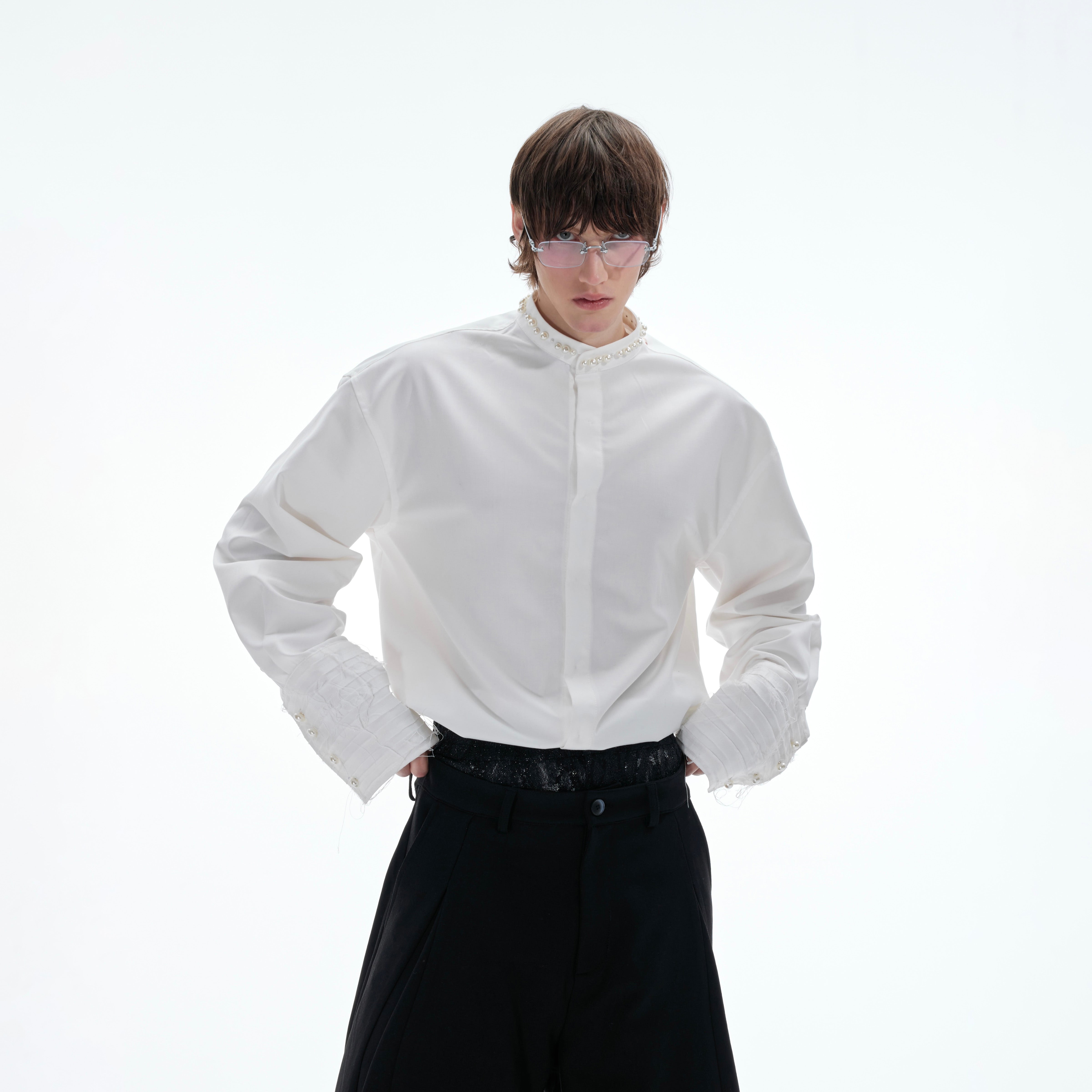 Close-up of exquisite baroque pearl details on puff sleeve blouse with delicate embroidery threadwork