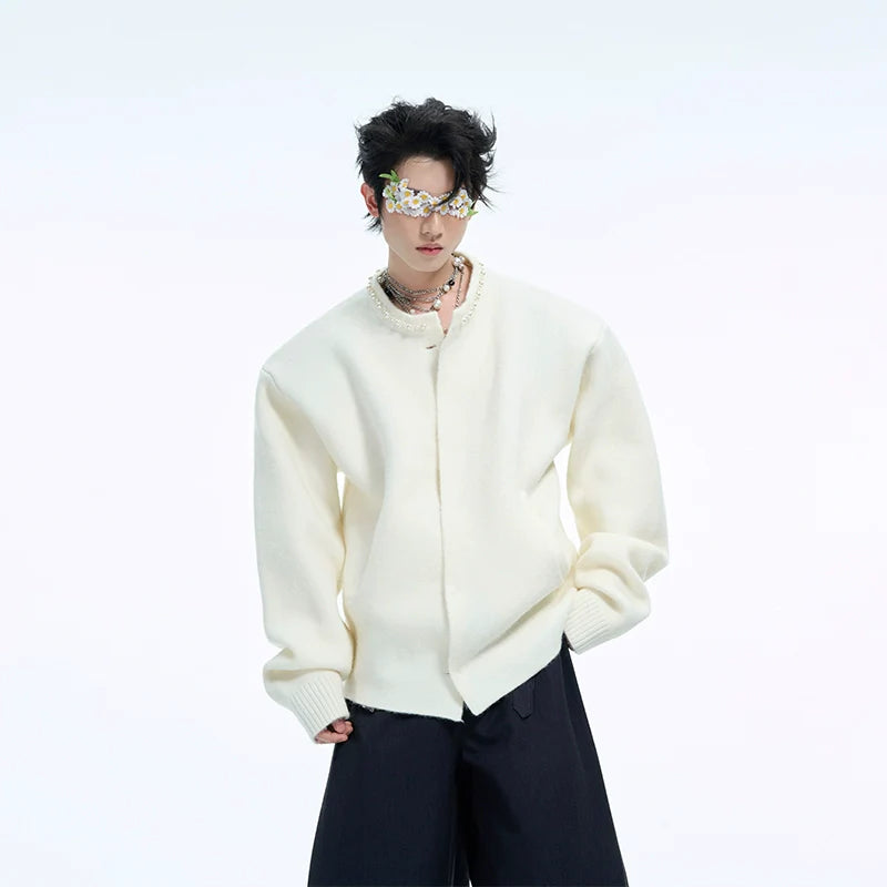 Front view of pearl-trimmed cropped cardigan showing elegant pearl embellishments on a soft oversized knit sweater