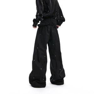 Side angle of distressed pleated cargo pants highlighting the deconstructed design and streetwear aesthetic