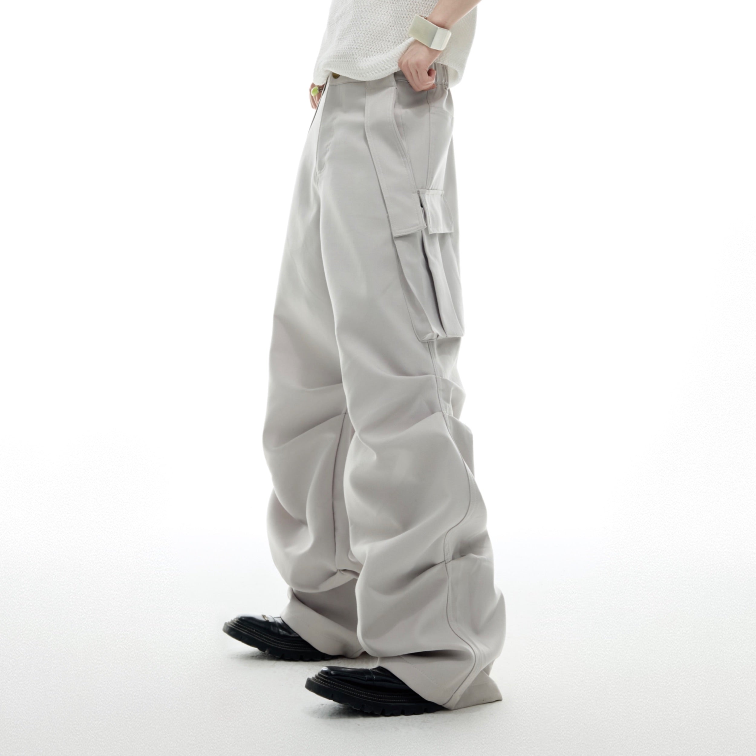 Side angle showing the pleated design and relaxed droopy fit of these statement cargo trousers