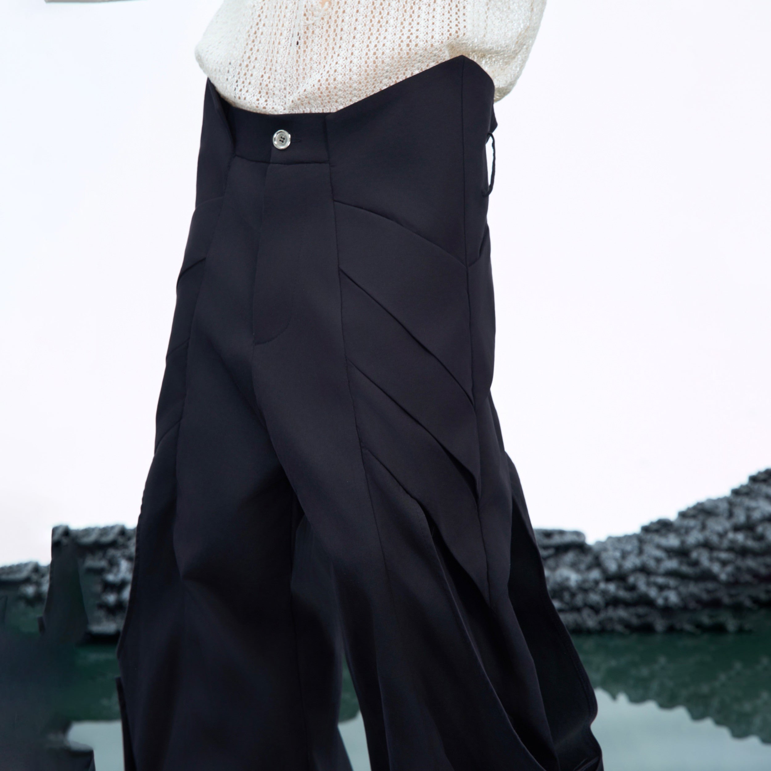 Side angle showing the unique pleated design and functional pockets on these avant-garde cargo pants