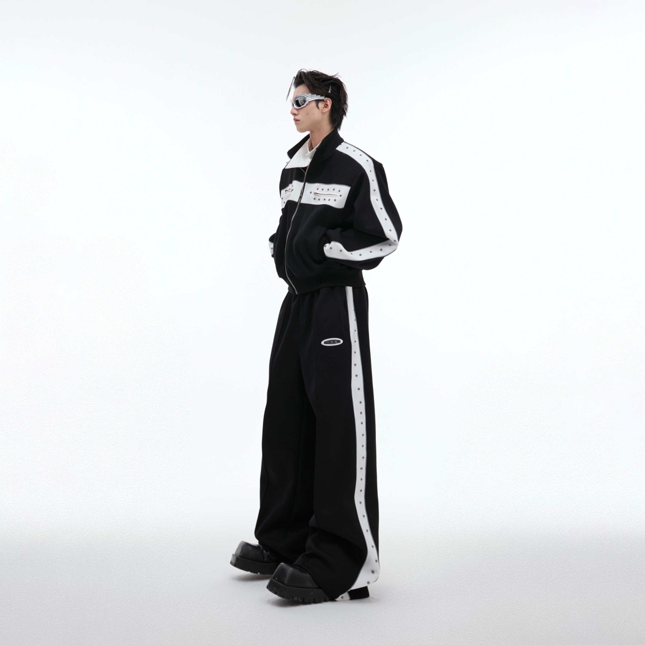 Back view of deconstructed pleated hoodie set showing unique high street tailoring and loose fit silhouette