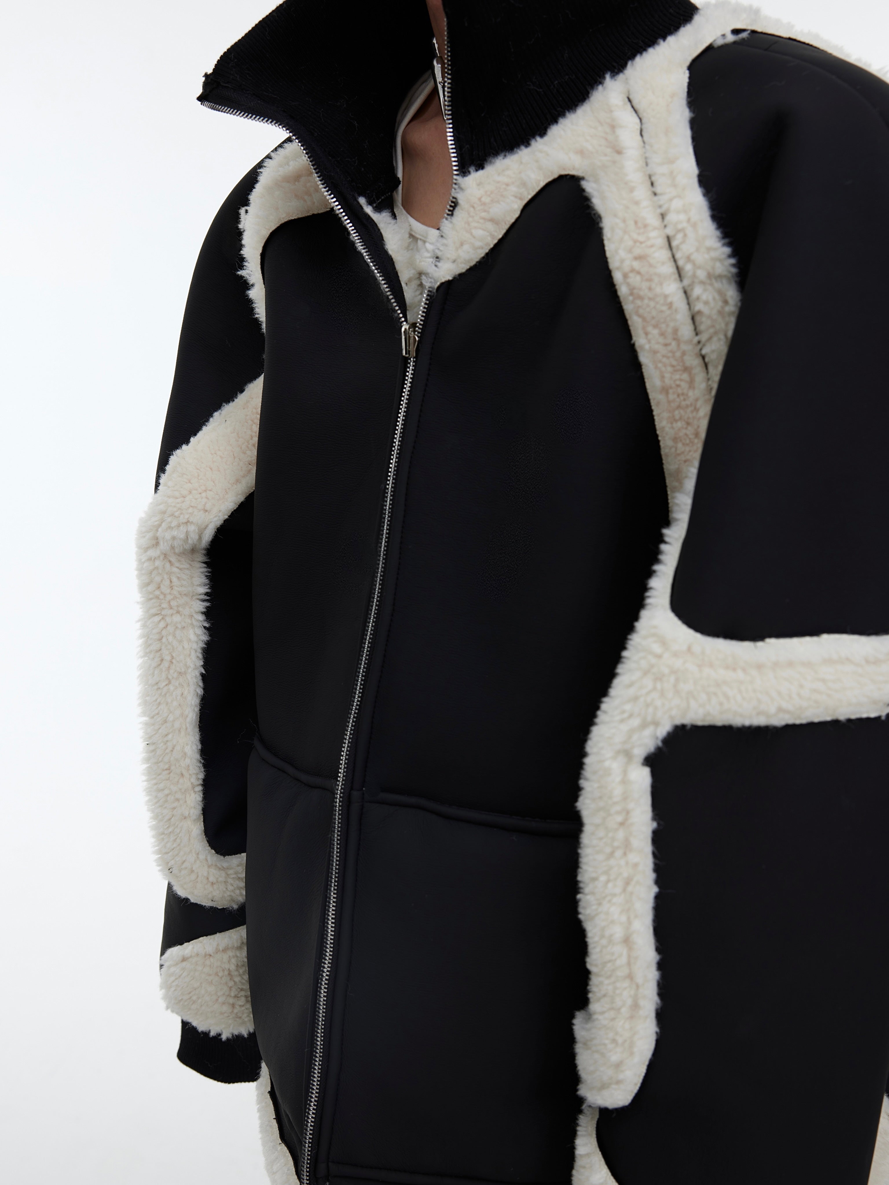 Close-up of color-blocking and pleated detailing on this deconstructed oversized coat