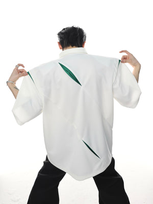 Close-up detail of premium metal buttons on this deconstructed streetwear polo top