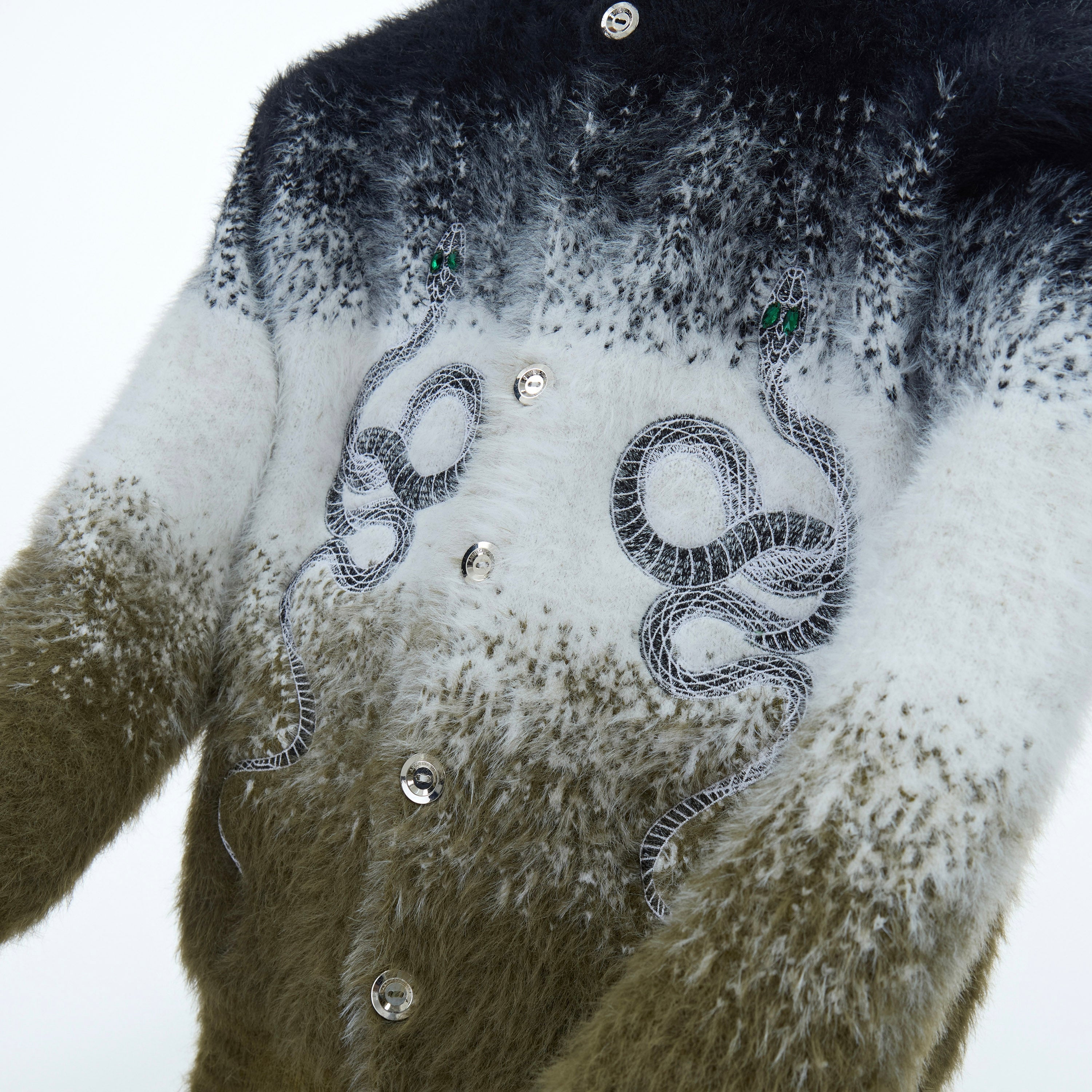 Close-up of premium mohair-blend cardigan showing unique custom logo detailing and texture