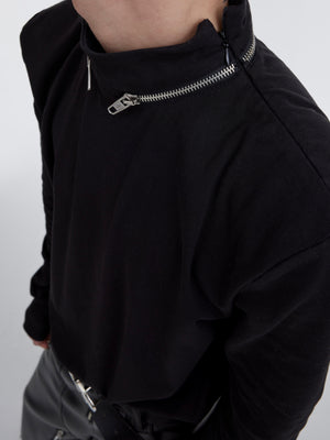 Close-up back view of the statement knit tee highlighting the signature metal-print ring collar design