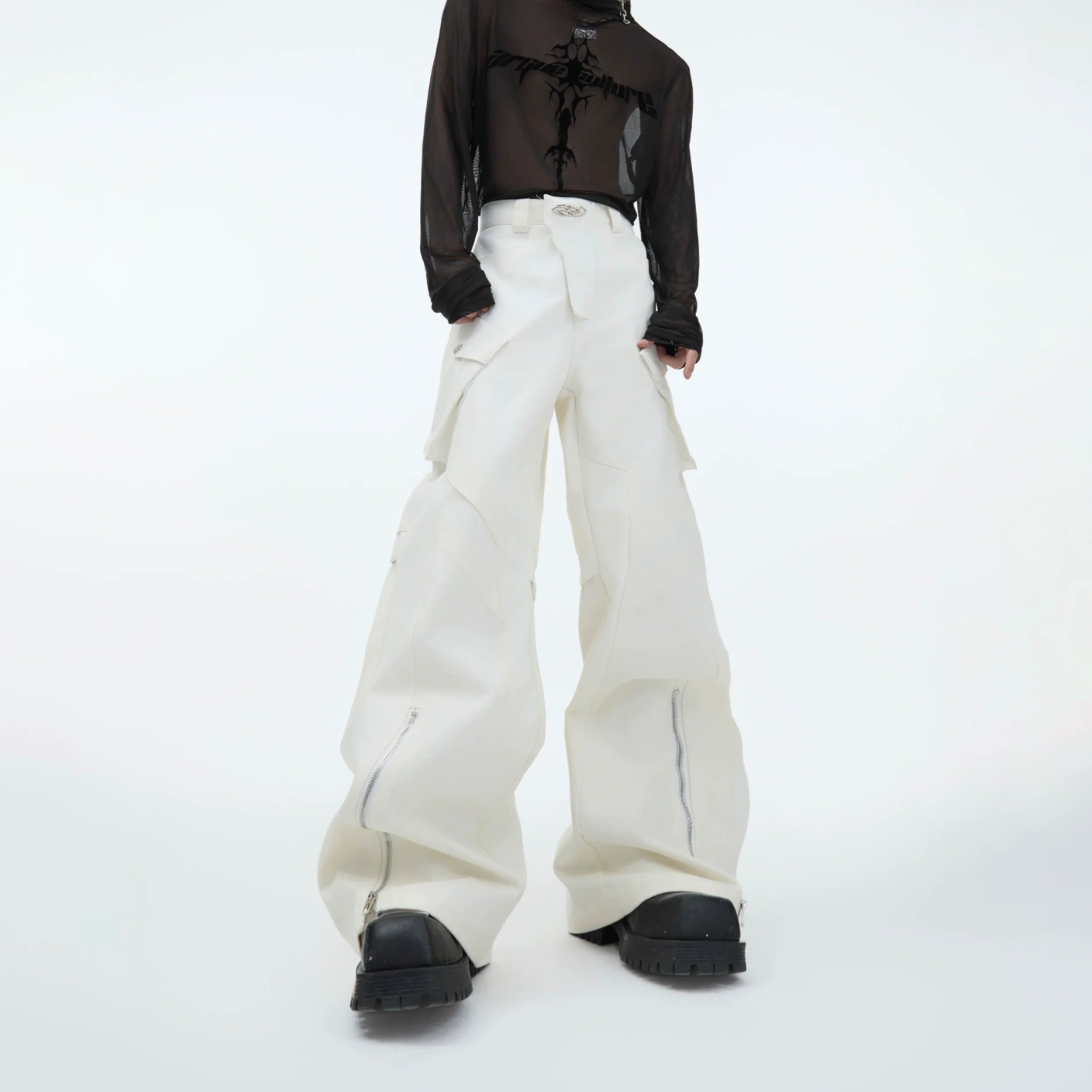 Front view of deconstructed PU-leather cargo pants showcasing signature patchwork design with urban streetwear style