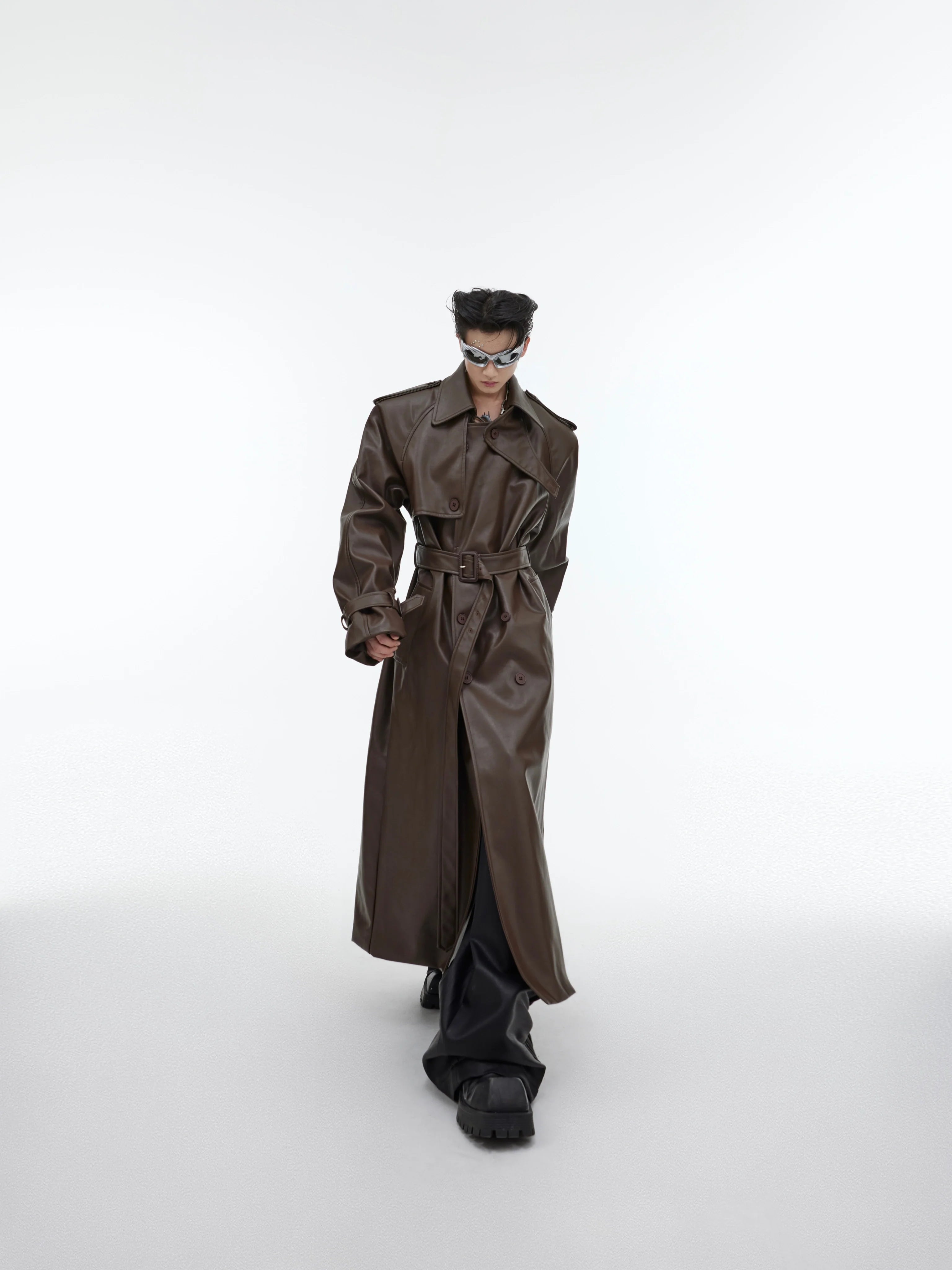Oversized PU leather trench coat with deconstructed shoulder pads, showcasing vintage-inspired streetwear style