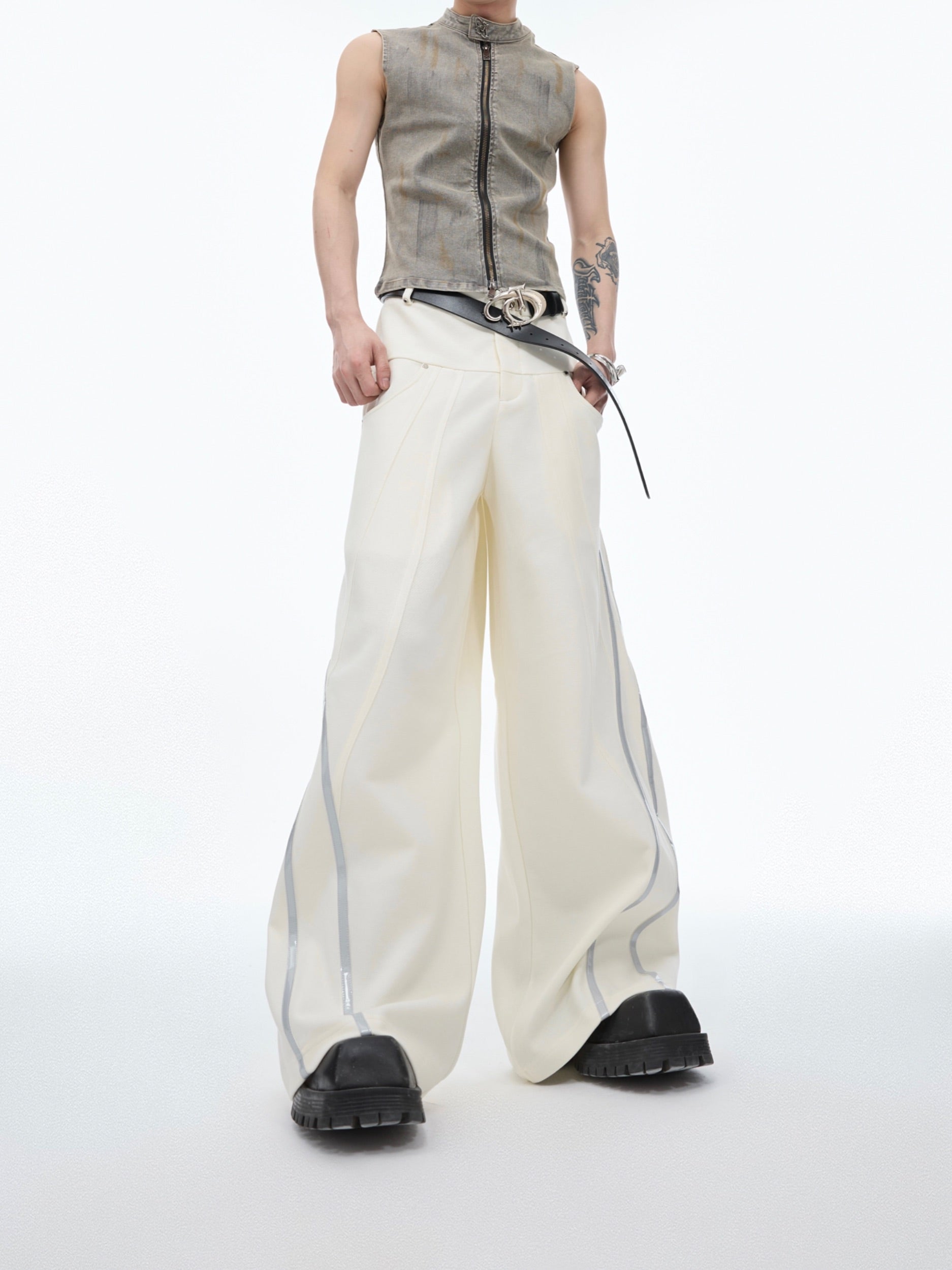 Reflective striped wide-leg pants with pleated texture, showcasing urban streetwear style and unique distressed details
