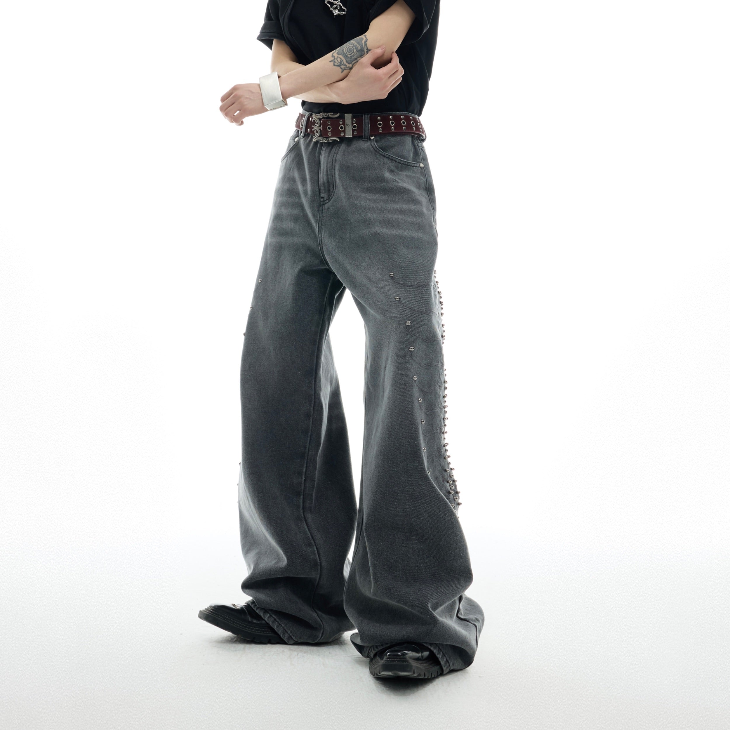 Close-up of back pocket design on retro rivet jeans with deconstructed edge and hardware accents