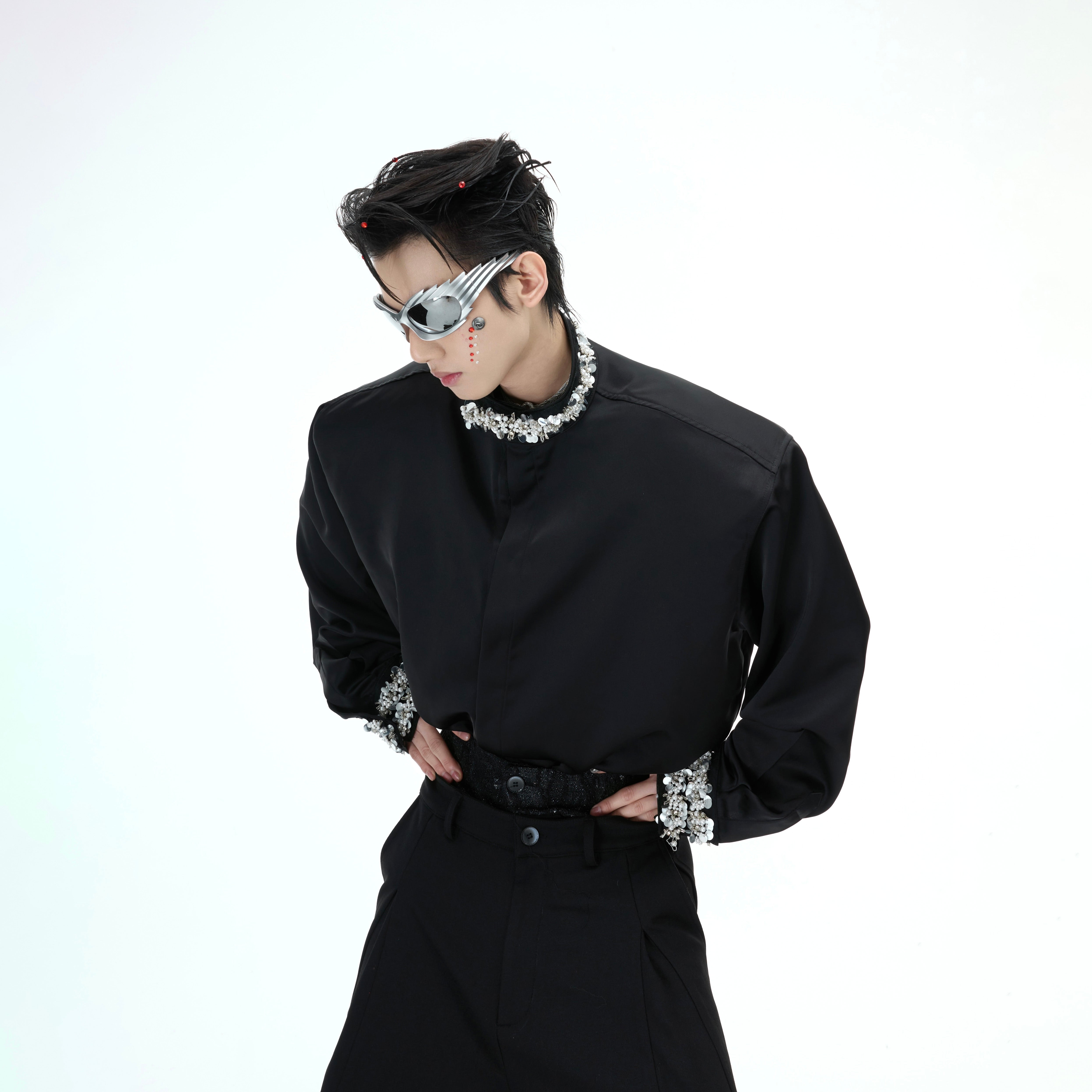 Close-up of the statement shoulder design on premium satin shirt with delicate pearl accents and diamond trim