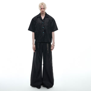 Front view of unique turquoise deconstructed shirt showing all patchwork and streetwear design elements