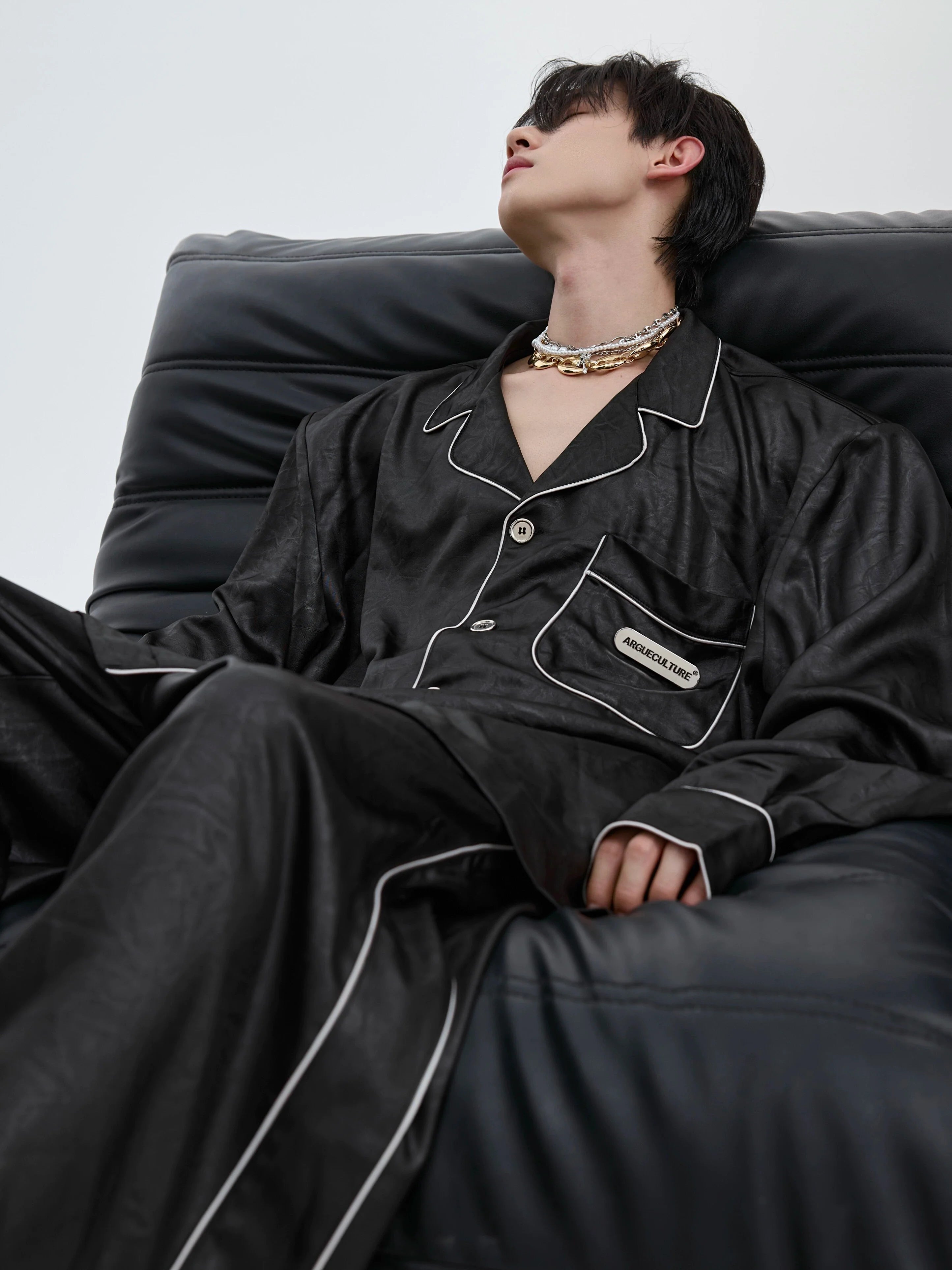 Luxury silk-satin loungewear set with padded shoulders, showcasing avant-garde sleepwear design for modern comfort