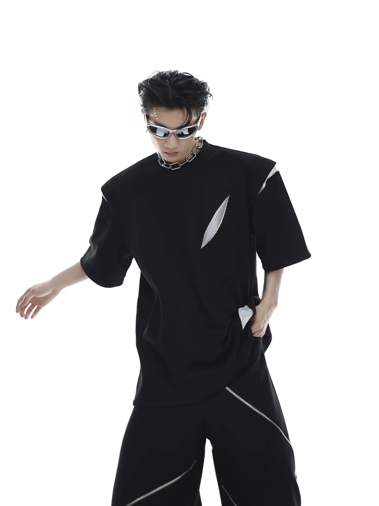 Deconstructed sleeveless tee featuring bold geometric cut-outs and mesh panels for avant-garde summer streetwear style