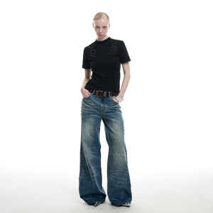 Close-up detail shot of handcrafted embroidery and beadwork on this edgy streetwear top