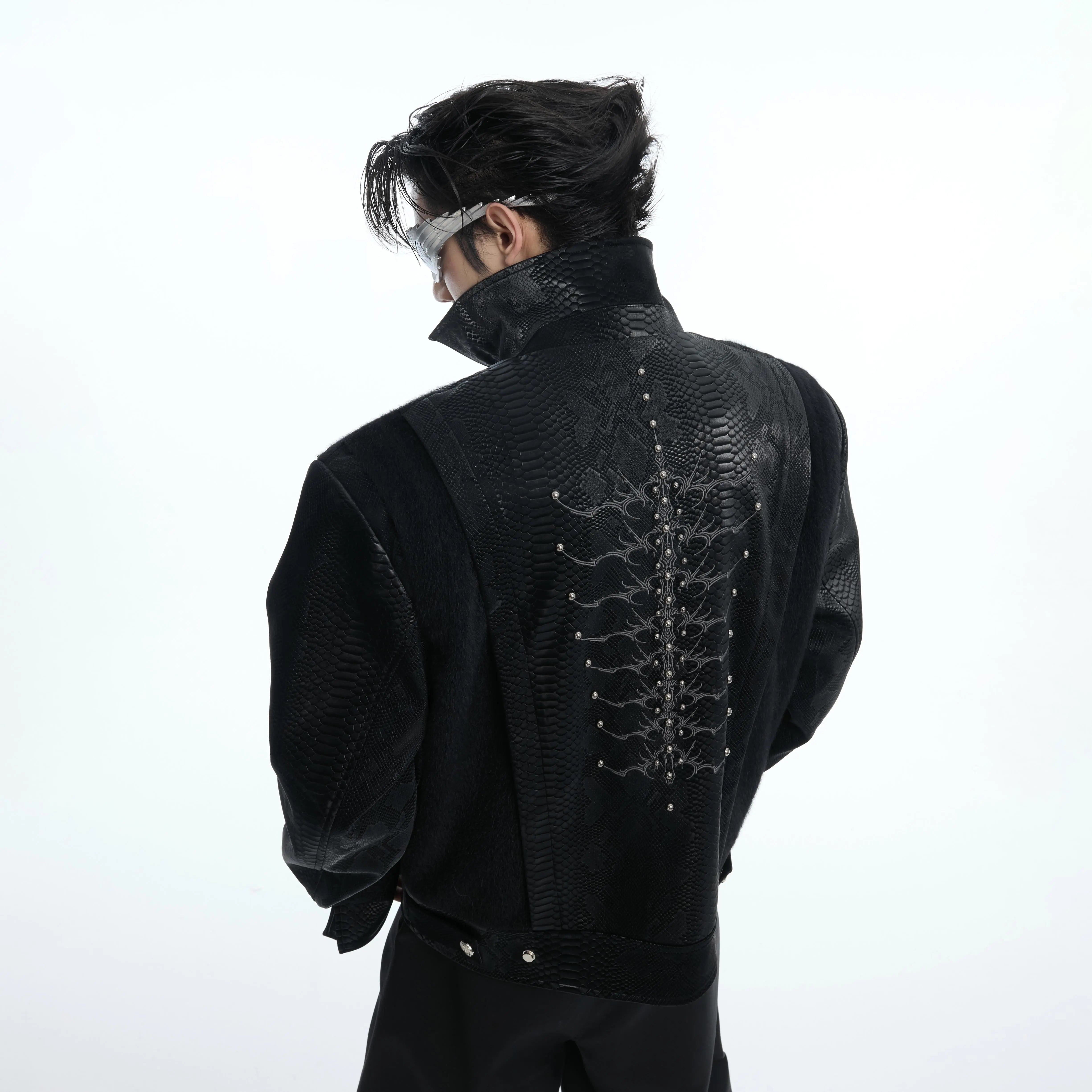 Front view of punk style snakeskin PU leather jacket with metal studs and snake-eye stitch detailing