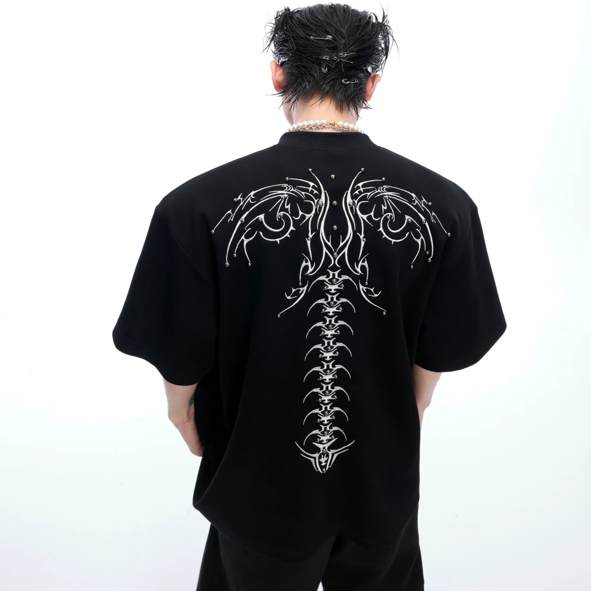 Men's oversized streetwear tee featuring bold snake eye spine embroidery design with 3D detailing