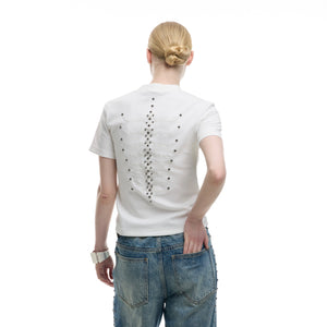 Layflat styling of statement streetwear top with snake eye spine and metal rivet accents