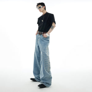 Side profile of statement-making denim jeans showing snake-eye studs and retro wash