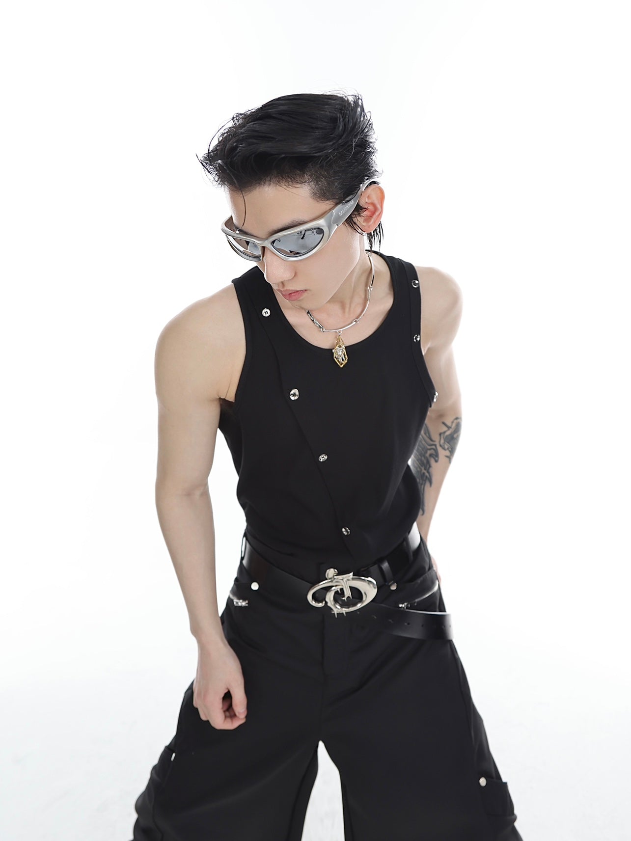 Front view of snake print ribbed knit vest with asymmetrical metallic buttons, avant-garde streetwear piece