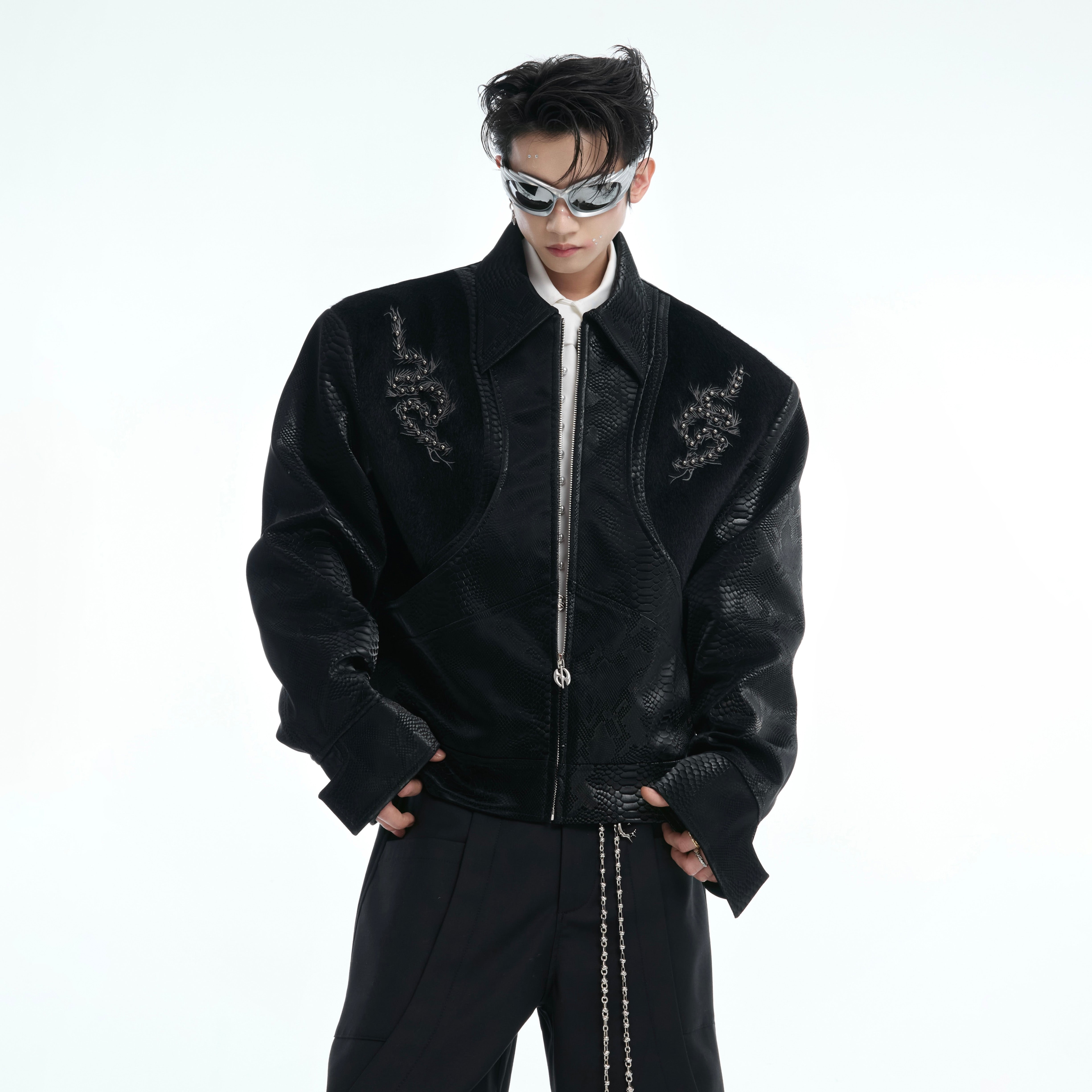 Back view of edgy leather jacket featuring bold star embroidery and snakeskin patchwork design