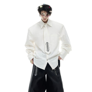 Close-up of unique spinal bone embroidery on deconstructed long-sleeve shirt showing intricate details