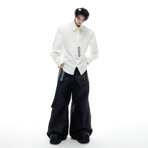 Back view of artistic spinal bone embroidery on loose-fit streetwear shirt with deconstructed elements