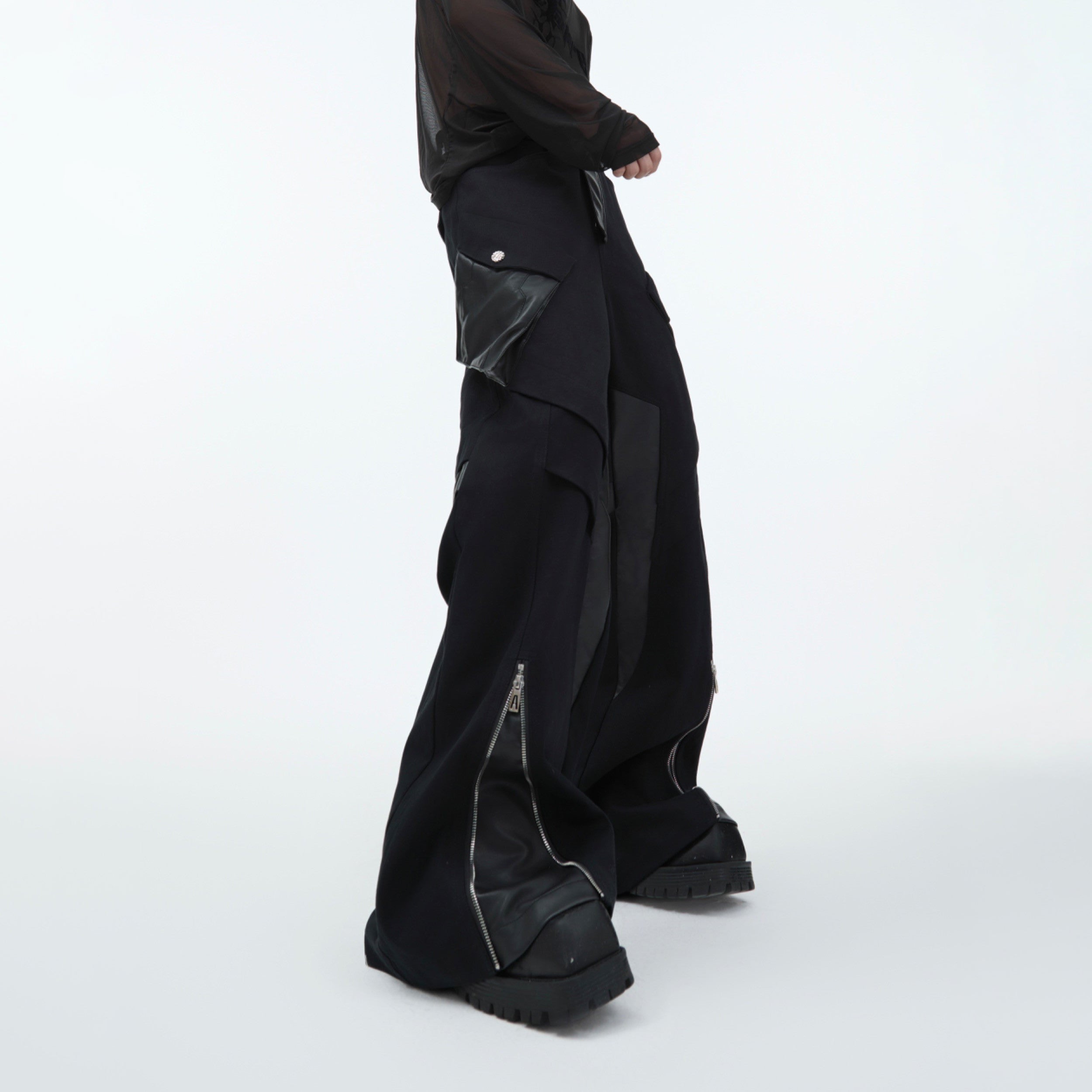 Side angle showing loose straight-leg fit and functional pockets on these unique streetwear cargo pants