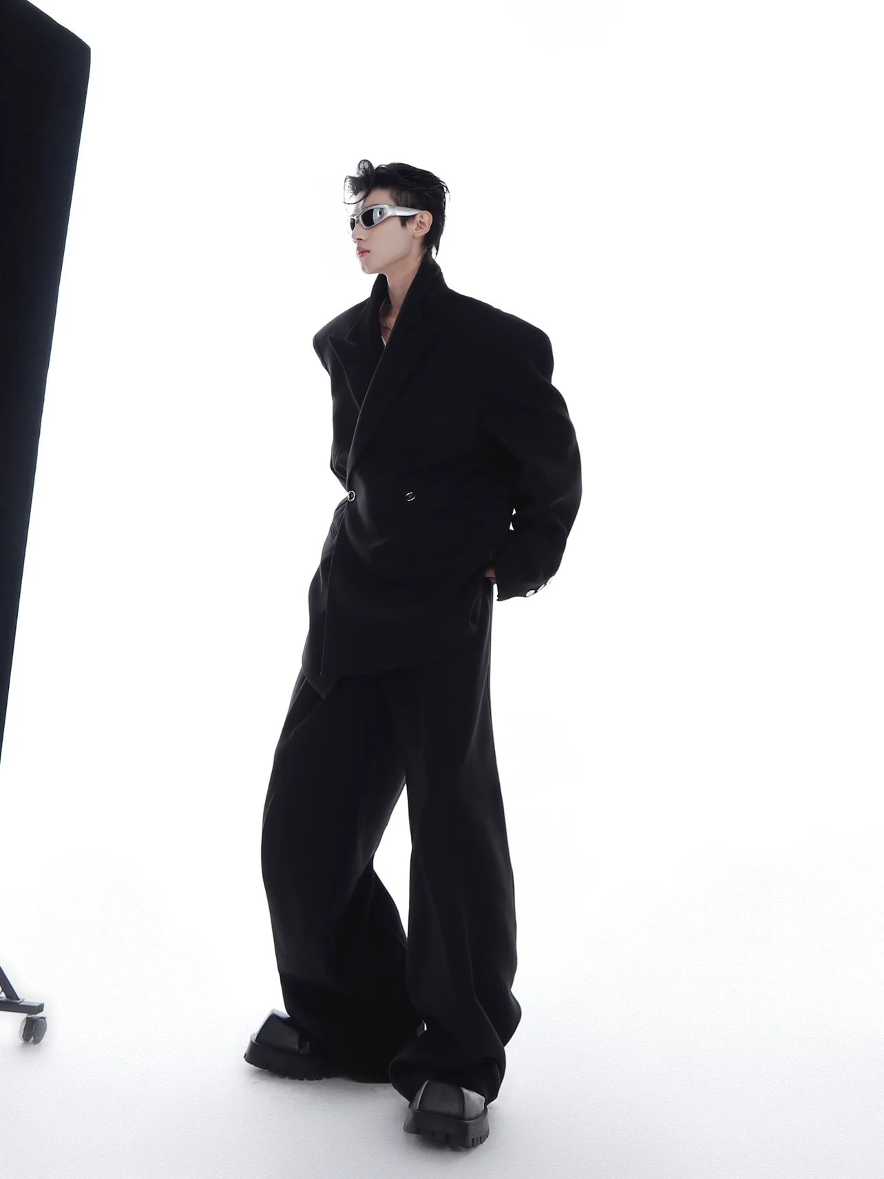 Gray avant-garde unisex suit set with statement shoulder pads and loose fit pants, perfect for edgy streetwear looks