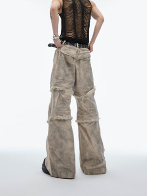 Side view of deconstructed tie-dye jeans showing functional cargo pockets and urban edge design