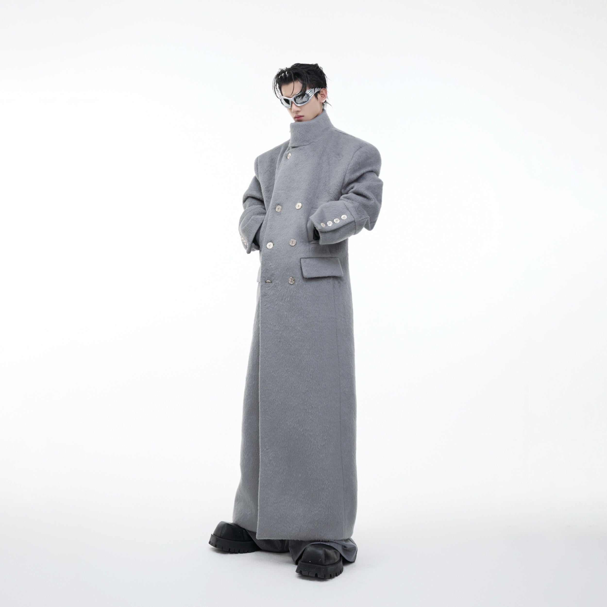 Front view of oversized wool trench coat showing stand collar and long streetwear silhouette