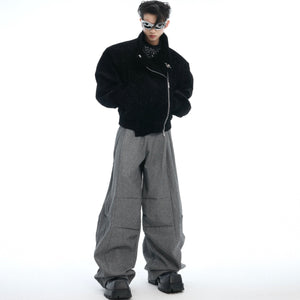 Close-up detail of how the pleats create dynamic movement in these drop-crotch trousers