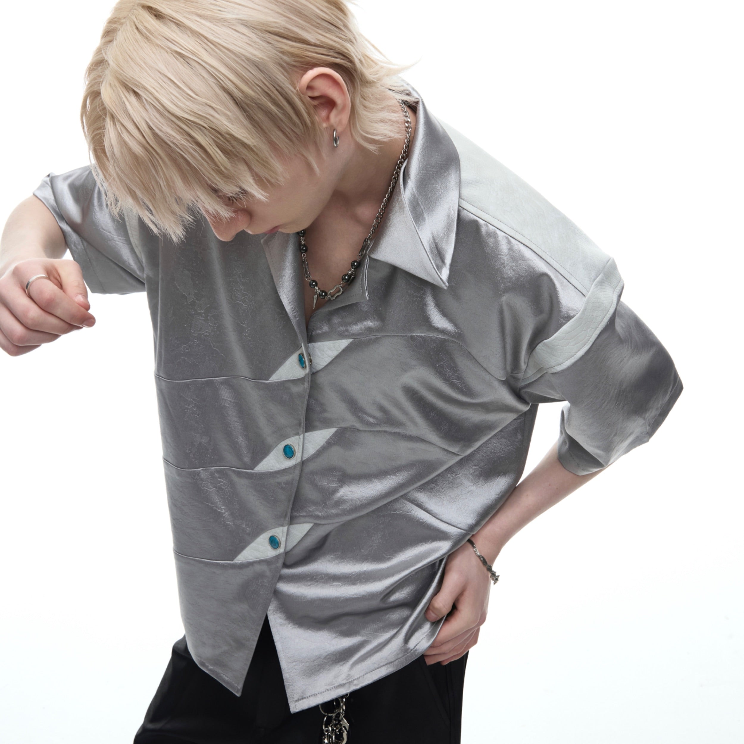 Close-up of vintage-inspired amber-toned buttons on the deconstructed streetwear shirt collar