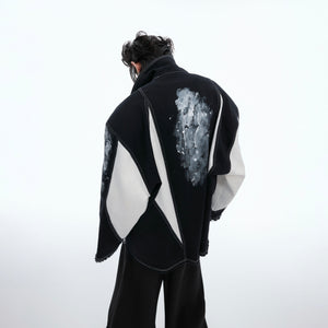 Close-up detail of padded shoulders on edgy art punk shirt-jacket with premium fabric construction