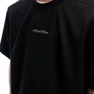 Fashion-forward styling of heavyweight short sleeve t-shirt layered with streetwear accessories