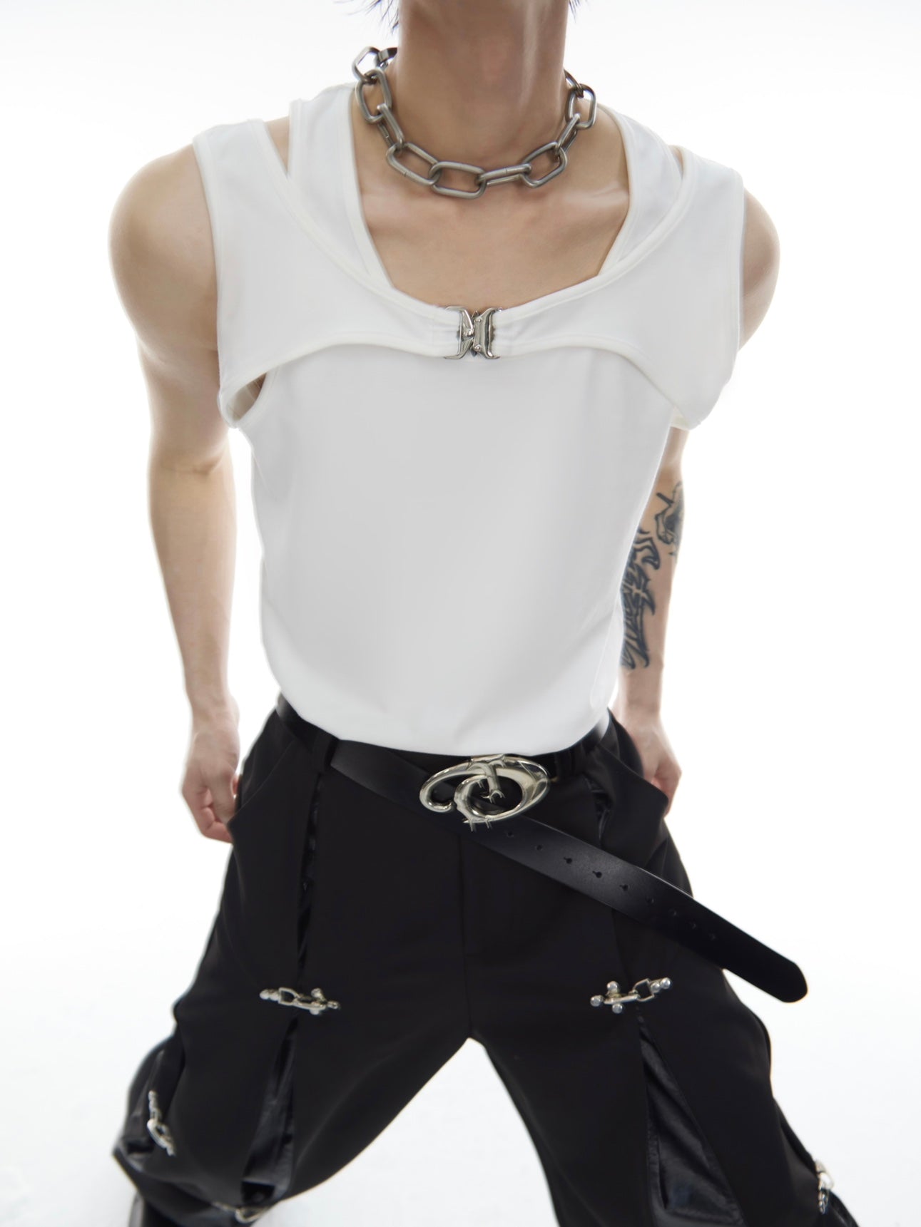 Back view of fashion tank top featuring prominent metal logo detail, perfect for summer streetwear outfits