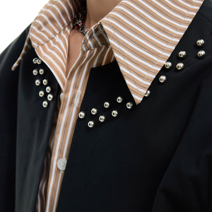 Model wearing the slim fit striped layered top showing the metal stud accents and urban style