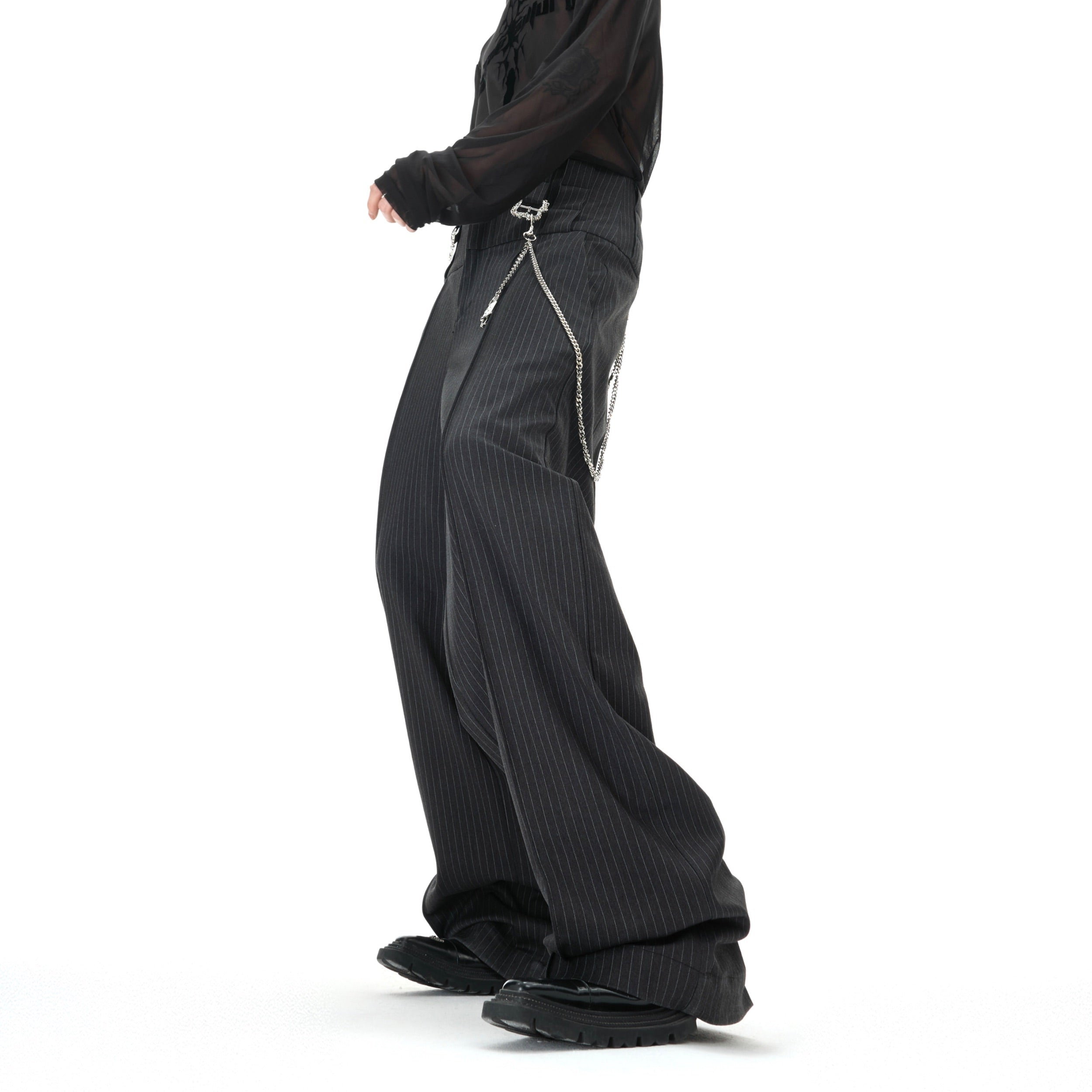 Side view of high-waisted retro striped pants showing the flattering straight-leg silhouette and metallic accents