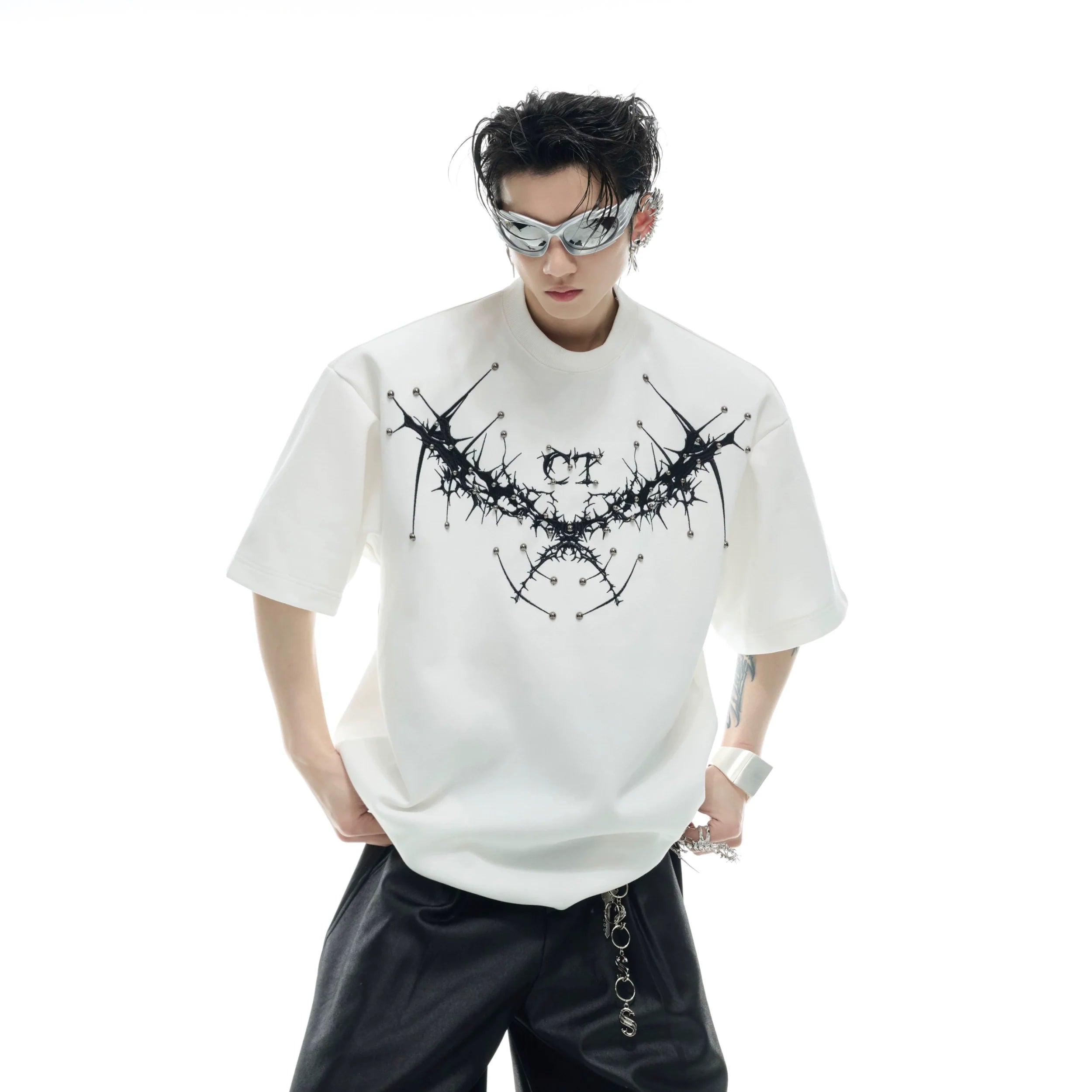 Front view of edgy oversized streetwear tee with metal studs and intricate embroidery details for summer fashion