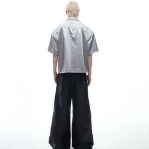 Detail shot of clean precision-stitched cuffs on deconstructed short-sleeve streetwear shirt