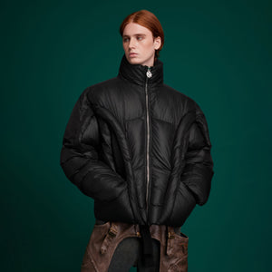 Full-length view of deconstructed cotton-padded jacket with urban winter streetwear style