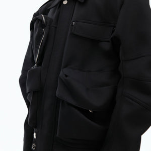 Front view showing the asymmetric zipper design and deconstructed elements of this unique techwear coat