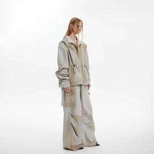 Close-up of strategic ruching details on distressed utility jacket with edgy urban style