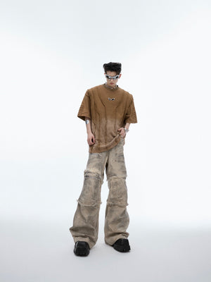 Front view of distressed cargo pants featuring artisanal craftsmanship with heavily worn knees and pockets