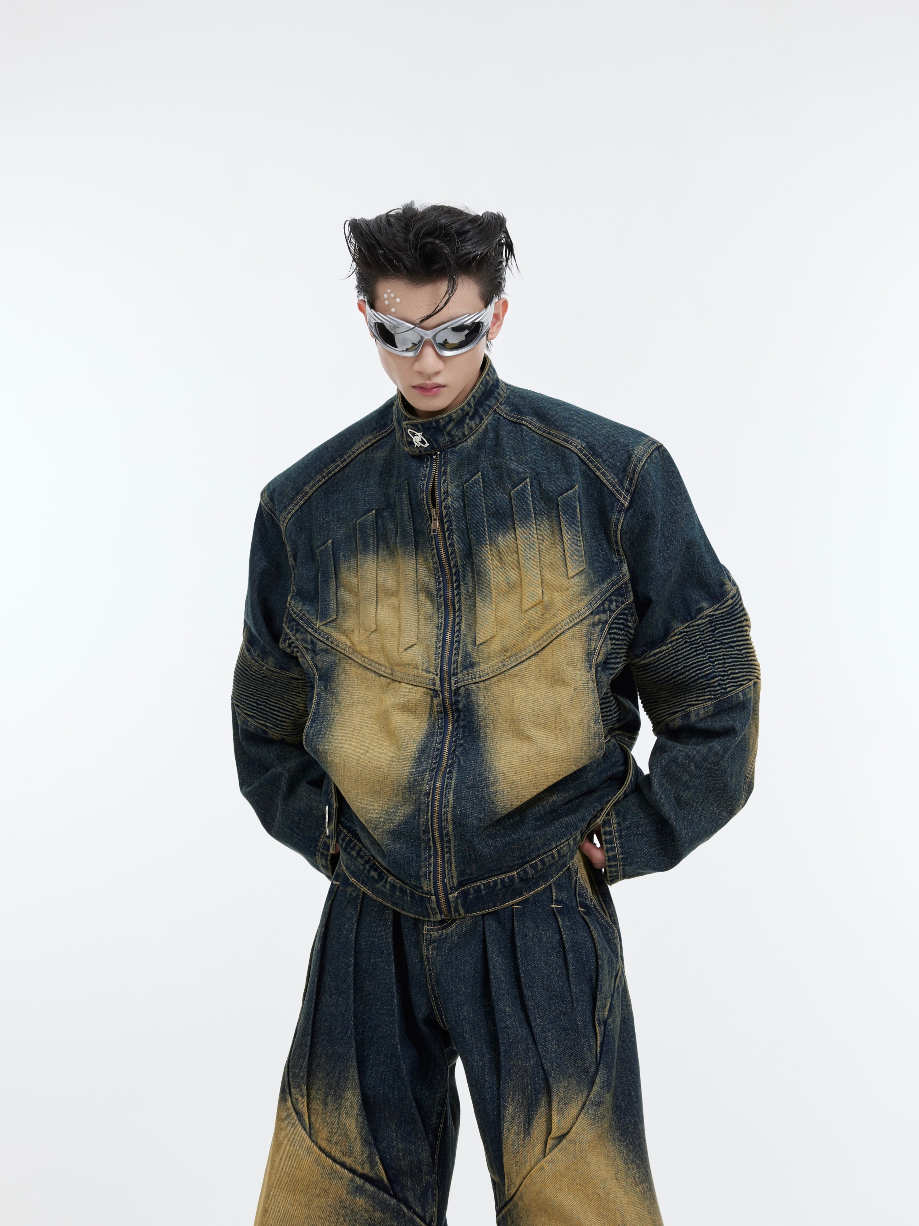 Front view of distressed denim jacket with 3D embossed detailing and deconstructed patchwork streetwear design