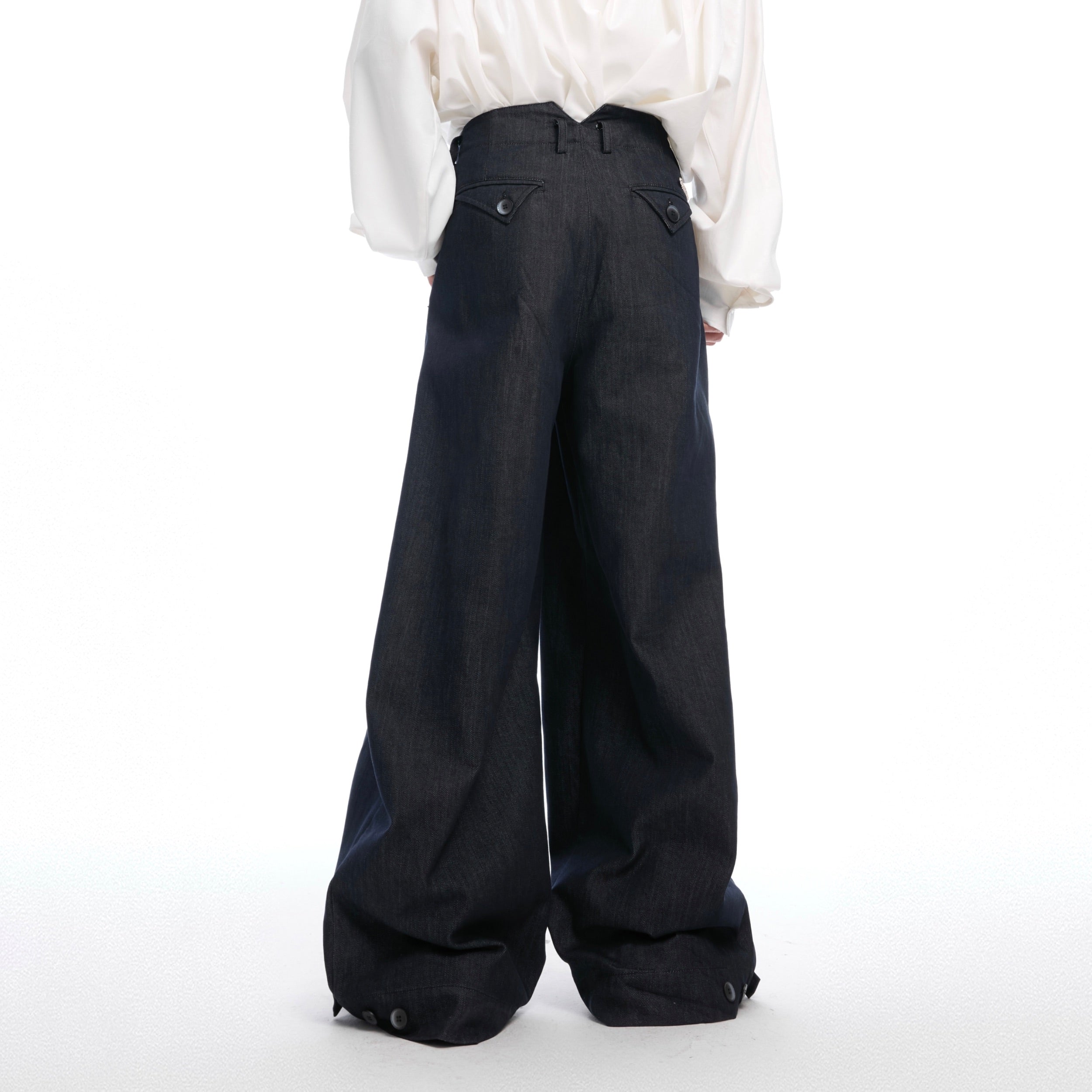 Back view of straight-cut vintage jeans featuring deconstructed design elements and streetwear edge