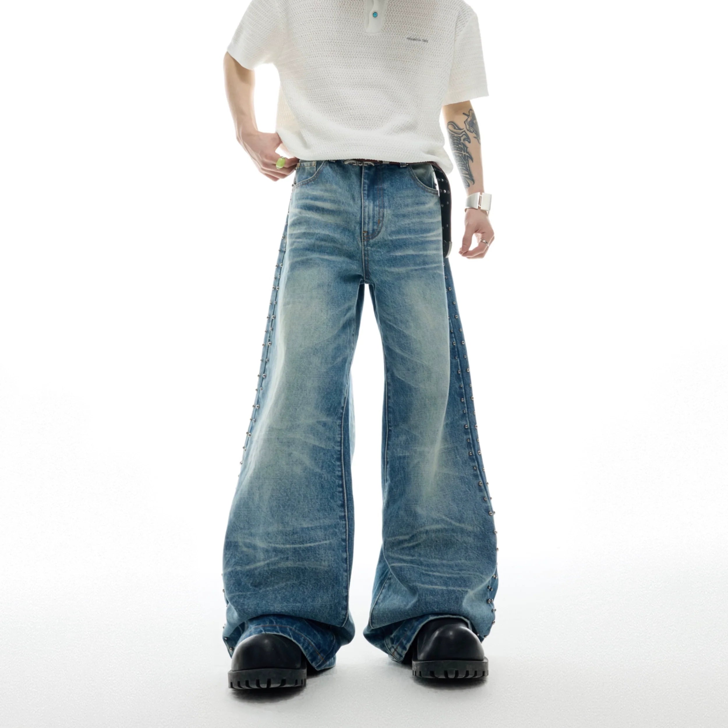 Vintage distressed straight-flare jeans with metal stud details and authentic wear patterns for retro street style