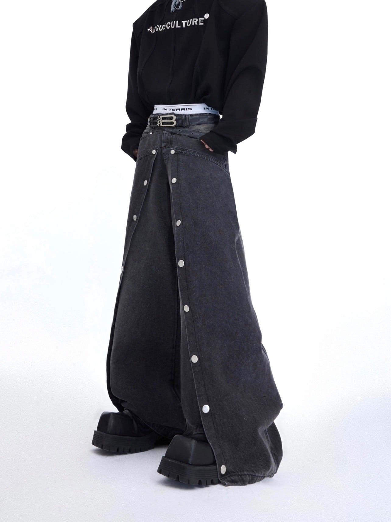 Vintage distressed straight-leg jeans with deconstructed metal detailing, showcasing punk-inspired streetwear style