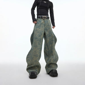 Close-up of the textured denim fabric with vintage oil painting effect and raw edge stitching details