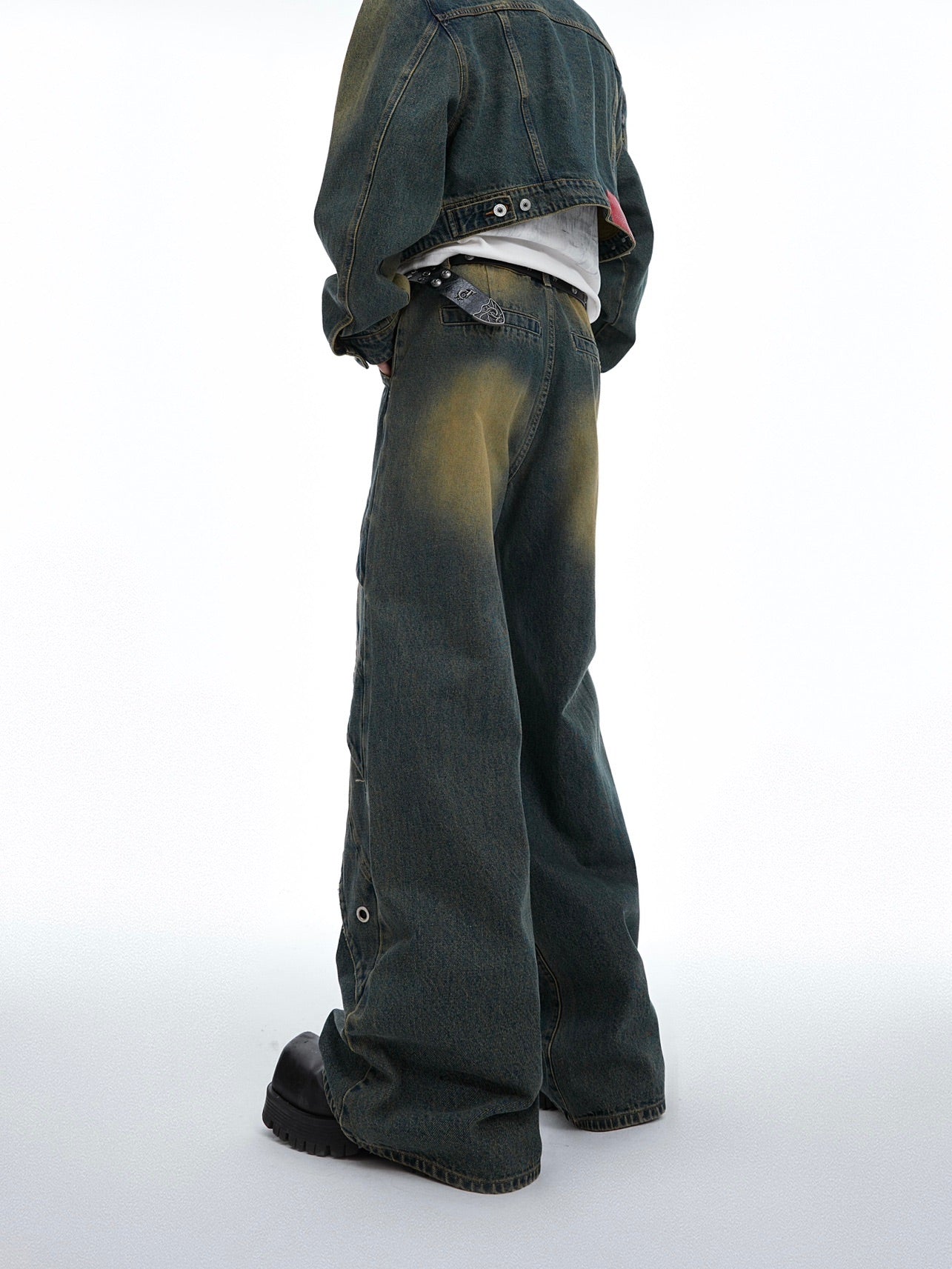 Close-up view of the frosted vintage texture on these pioneer-style jeans showing unique dye patterns